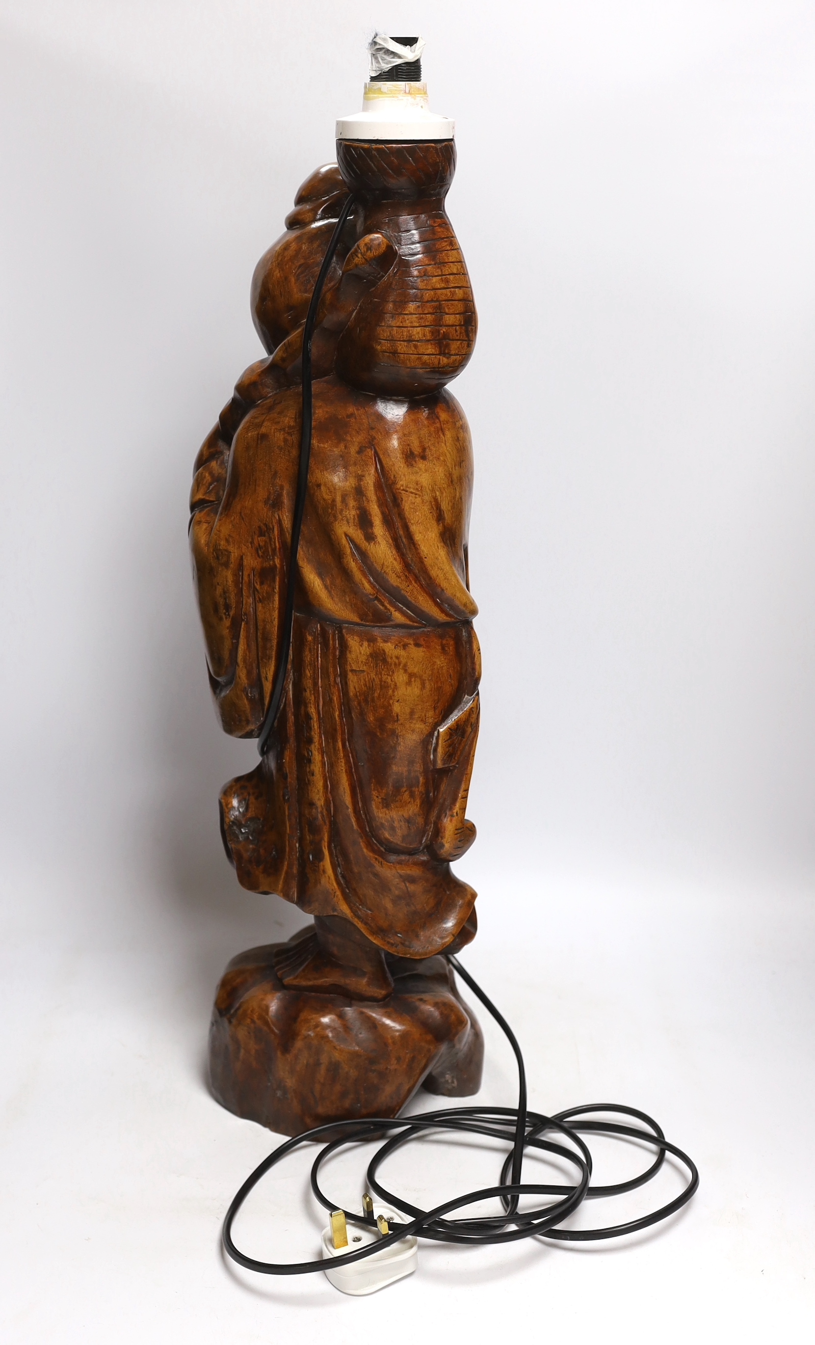 A Chinese carved wood figural lamp, 65cm high